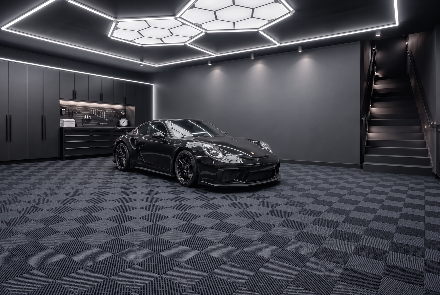 Dark modern garage with a performance car parked on a PITDECK modular floor